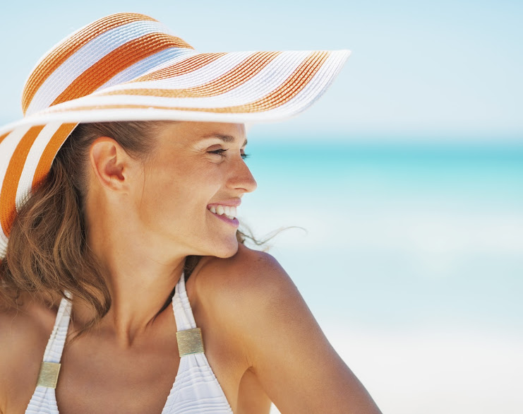 A woman smiling at the beach